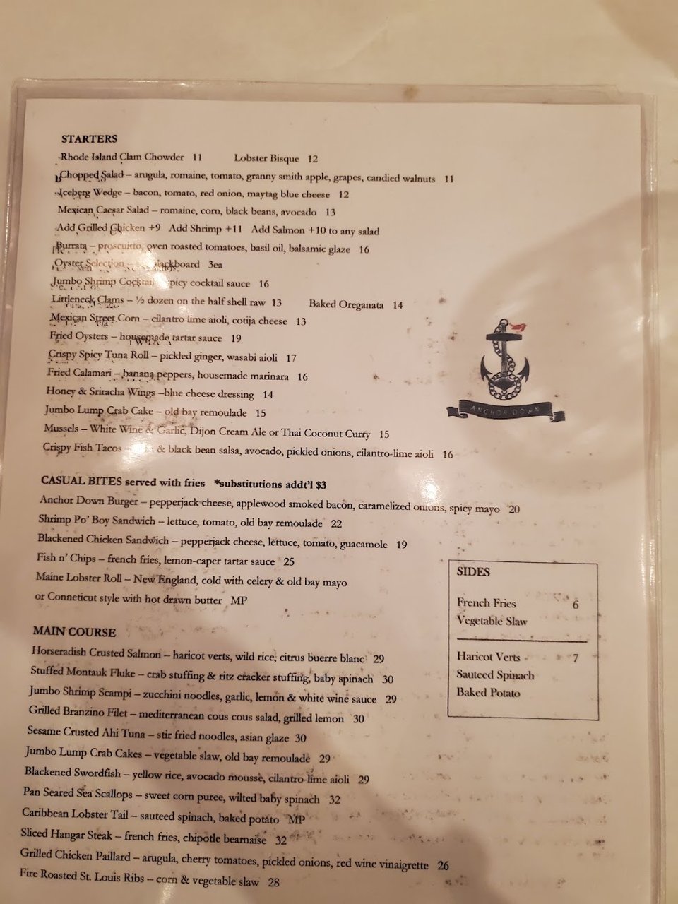 Restaurant menu beside place settings